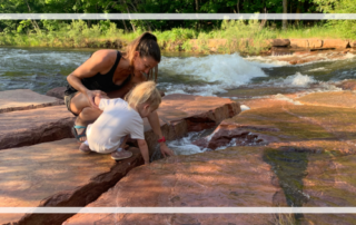 toddler and mother by a creek