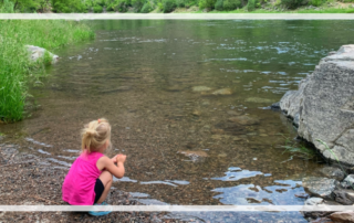 Camping with a toddler looking at creek